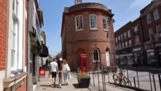 an old round fronted building in the sun