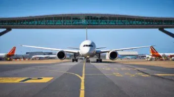 Photo of Gatwick runway featuring a bridge and plane.