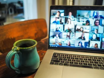 Computer screen and blue cup showing online training